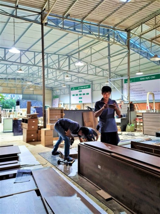 Nhân viên xưởng gỗ phối hợp làm việc